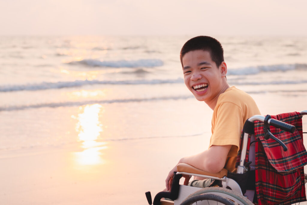 A person in a wheelchair at the beach