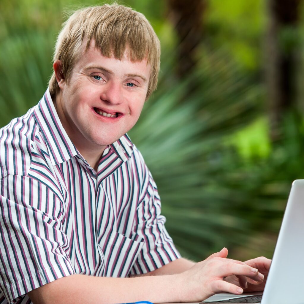 Self-advocate learning online using a laptop.