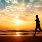 A man running on a beach showing that people with Down syndrome can run marathons and more!