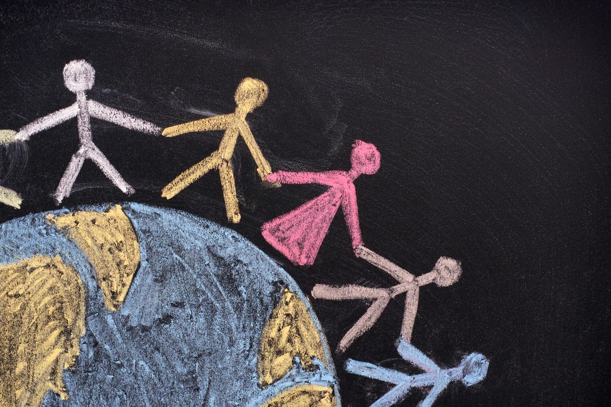 A chalk drawing of people holding hands while standing around the earth represents that you can build your circle of support.