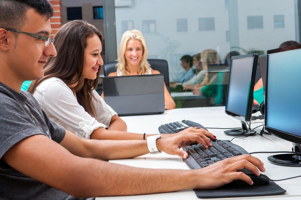 Three self-advocates using free back-to-school resources on desktop computers