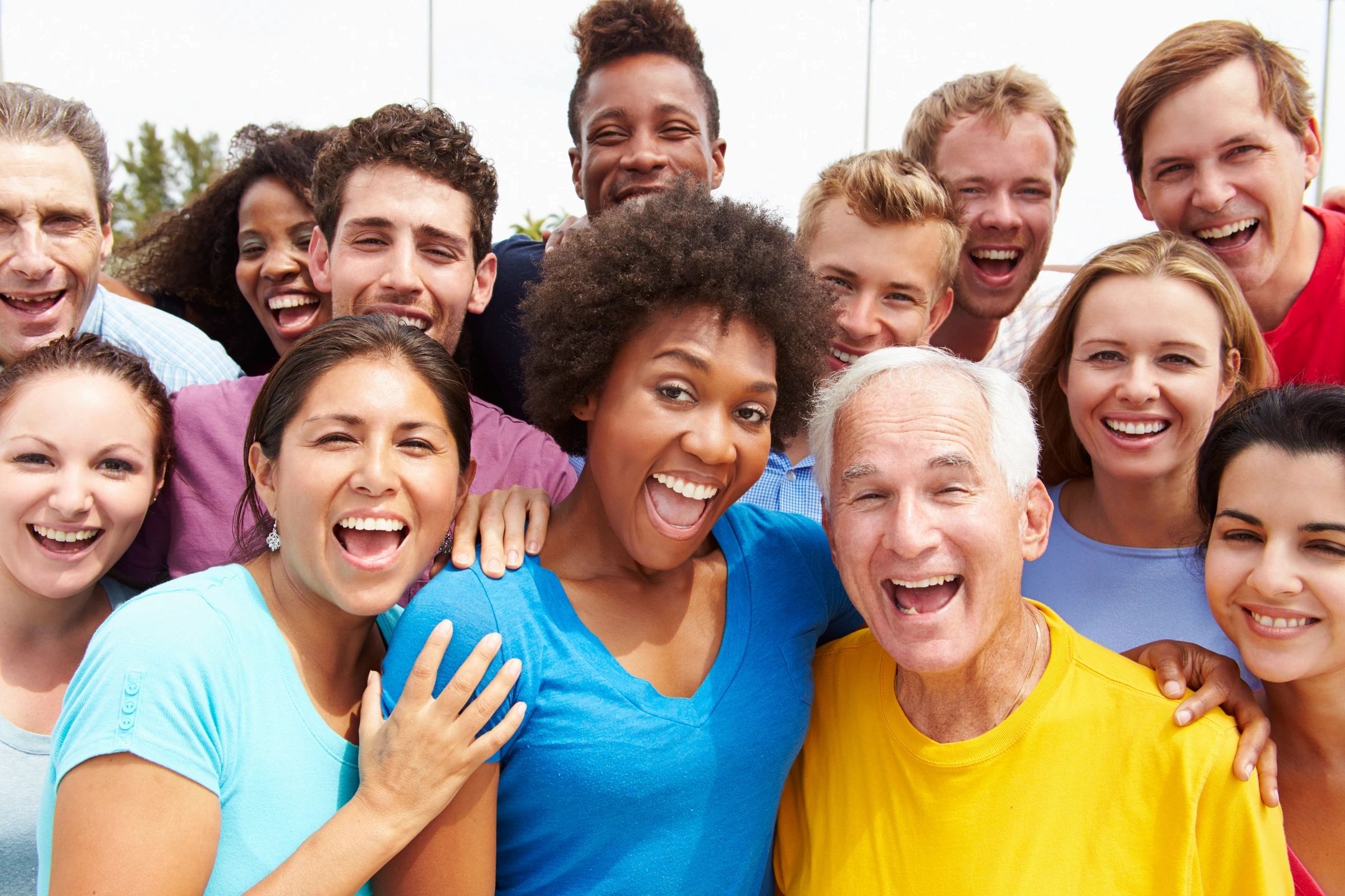 A group of people with different ages and different ethnicities representing found family supporting each other